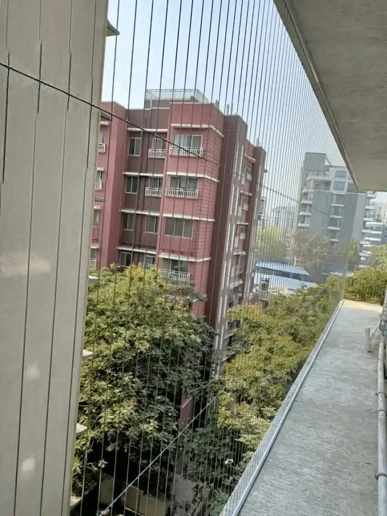 High-rise balcony fitted with an invisible safety grill at dusk
